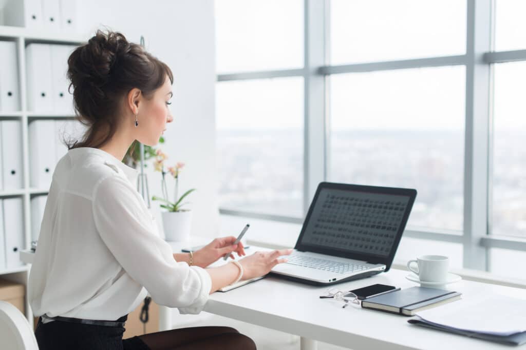Rear,View,Portrait,Of,A,Businesswoman,Sitting,On,Her,Workplace