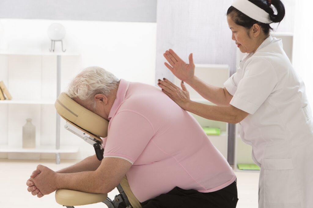 Overweight,Man,Having,Massage,In,A,Massage,Chair