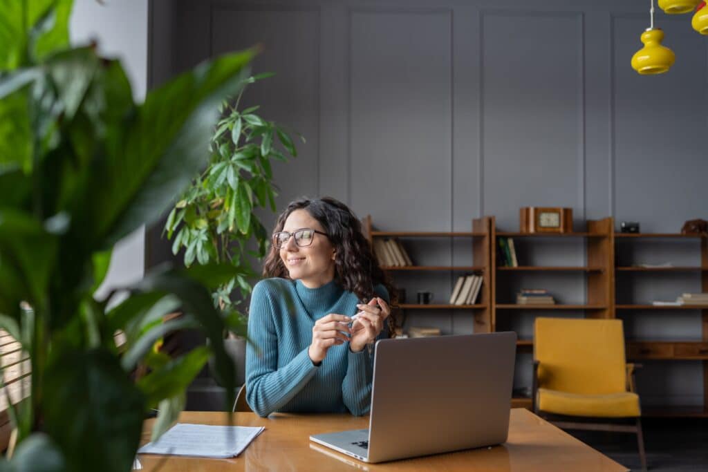 Happy,Female,Employee,Looking,In,Window,With,Satisfied,Face,Expression
